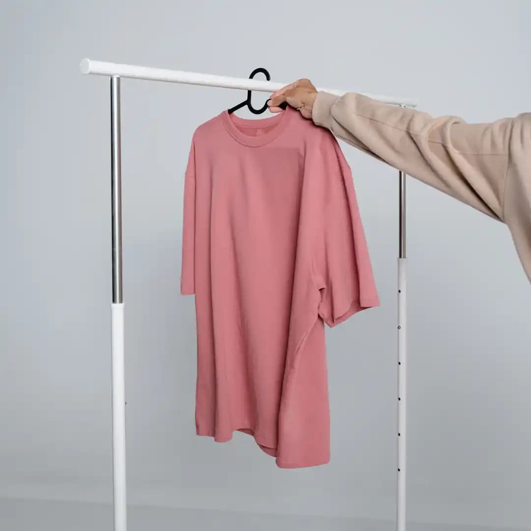 A photo of a man placing a garment on a line
